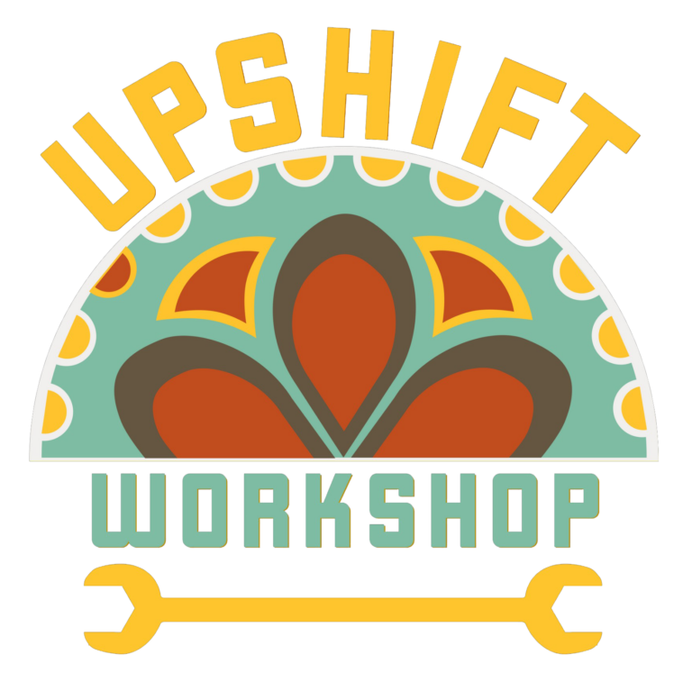 Logo with the words "UPSHIFT WORKSHOP," featuring bold yellow "UPSHIFT" text above a colorful patterned semicircle and "WORKSHOP" in gray block letters, flanked by two yellow wrenches.