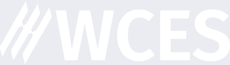 White letters "WCES" in bold, uppercase font next to a stylized logo with three diagonal lines, all on a light gray background.