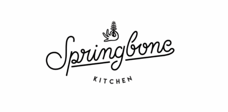 Logo for "Springbone Kitchen" with the word "Springbone" in cursive script, underlined, and a small bird holding a sprig above the text. "KITCHEN" is printed in uppercase letters below the underline.